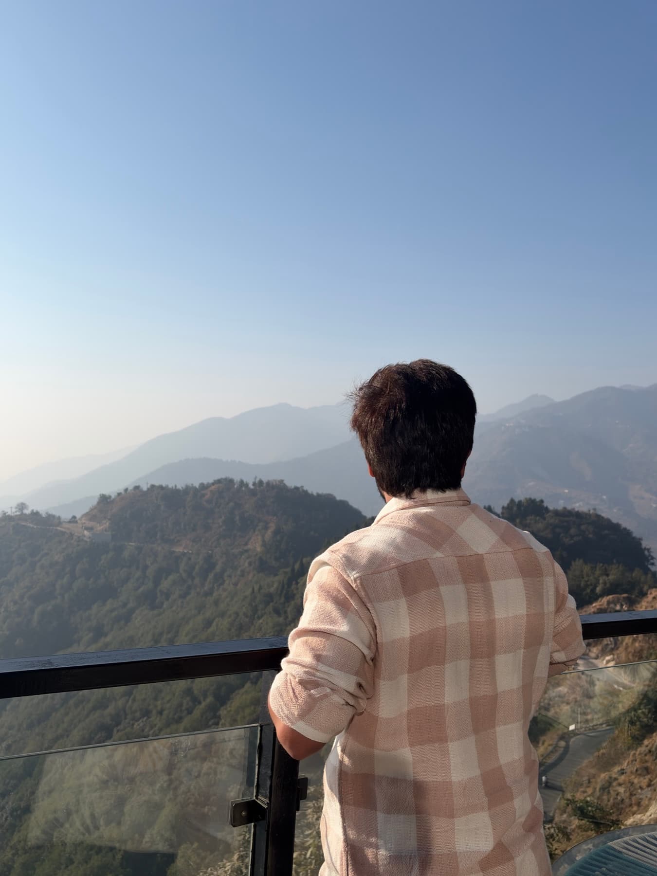 Mohit looking out over hills from a viewpoint