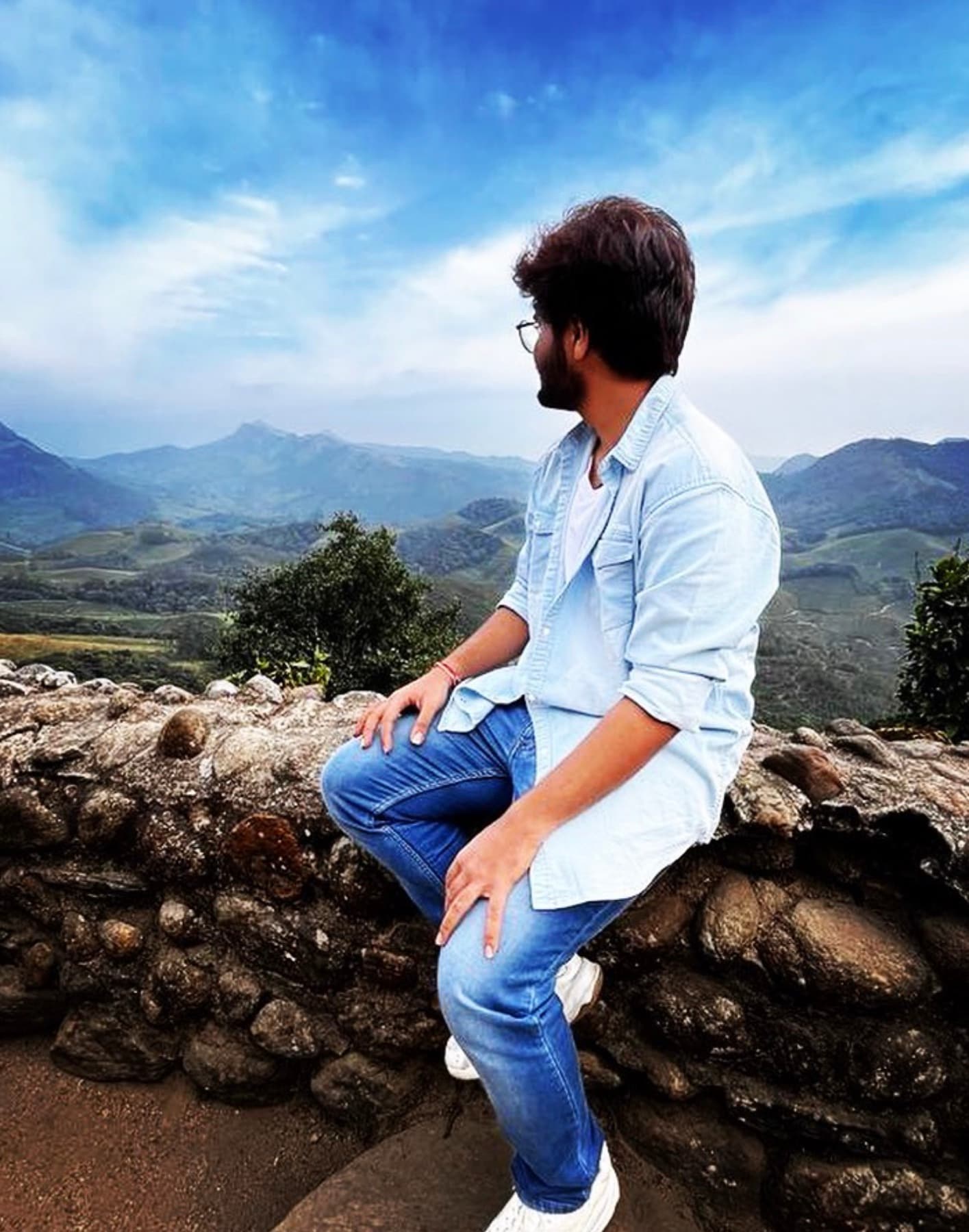 Mohit sitting near a mountain viewpoint