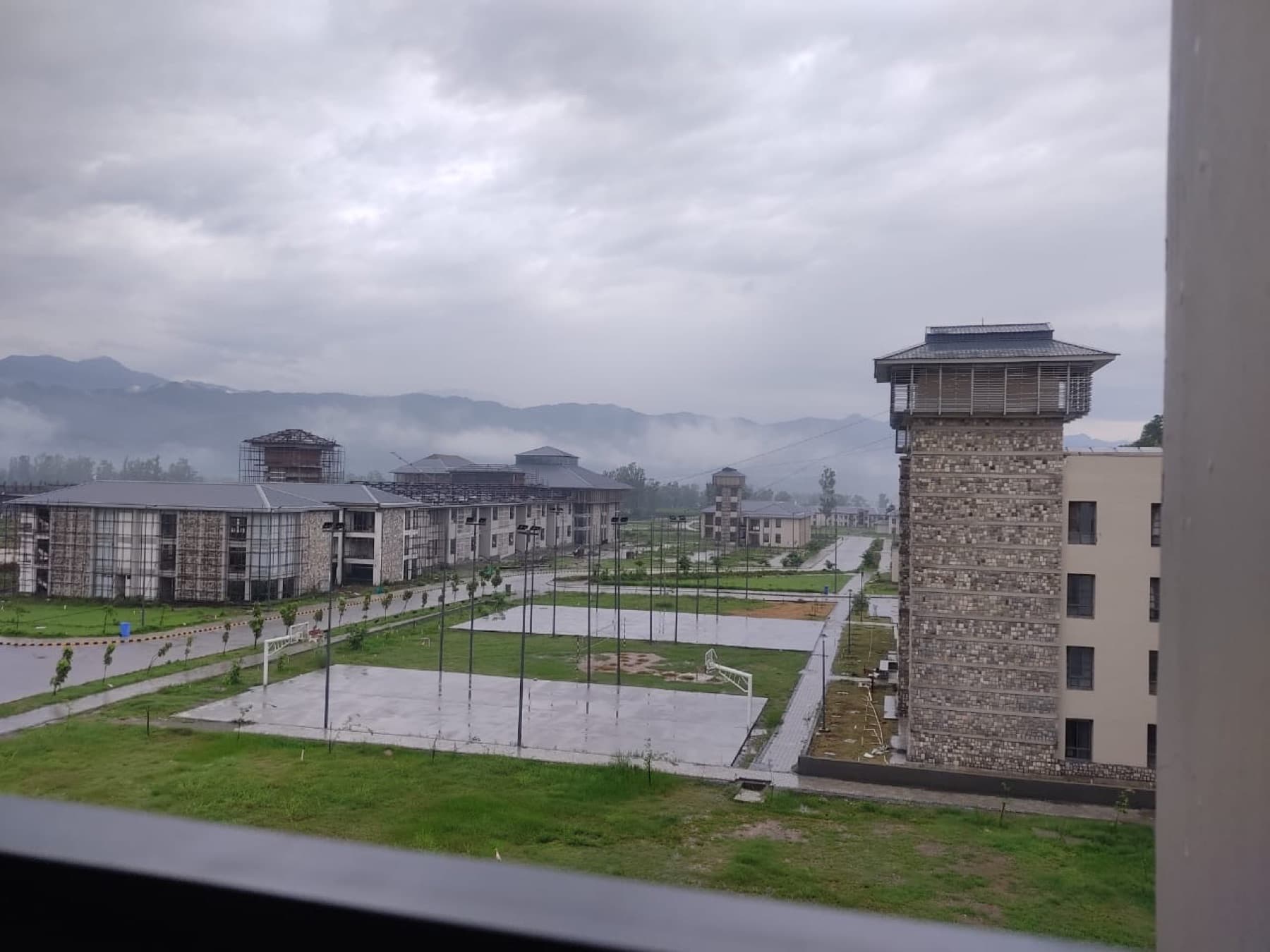 Rainy view of IIM Sirmaur campus and surrounding hills
