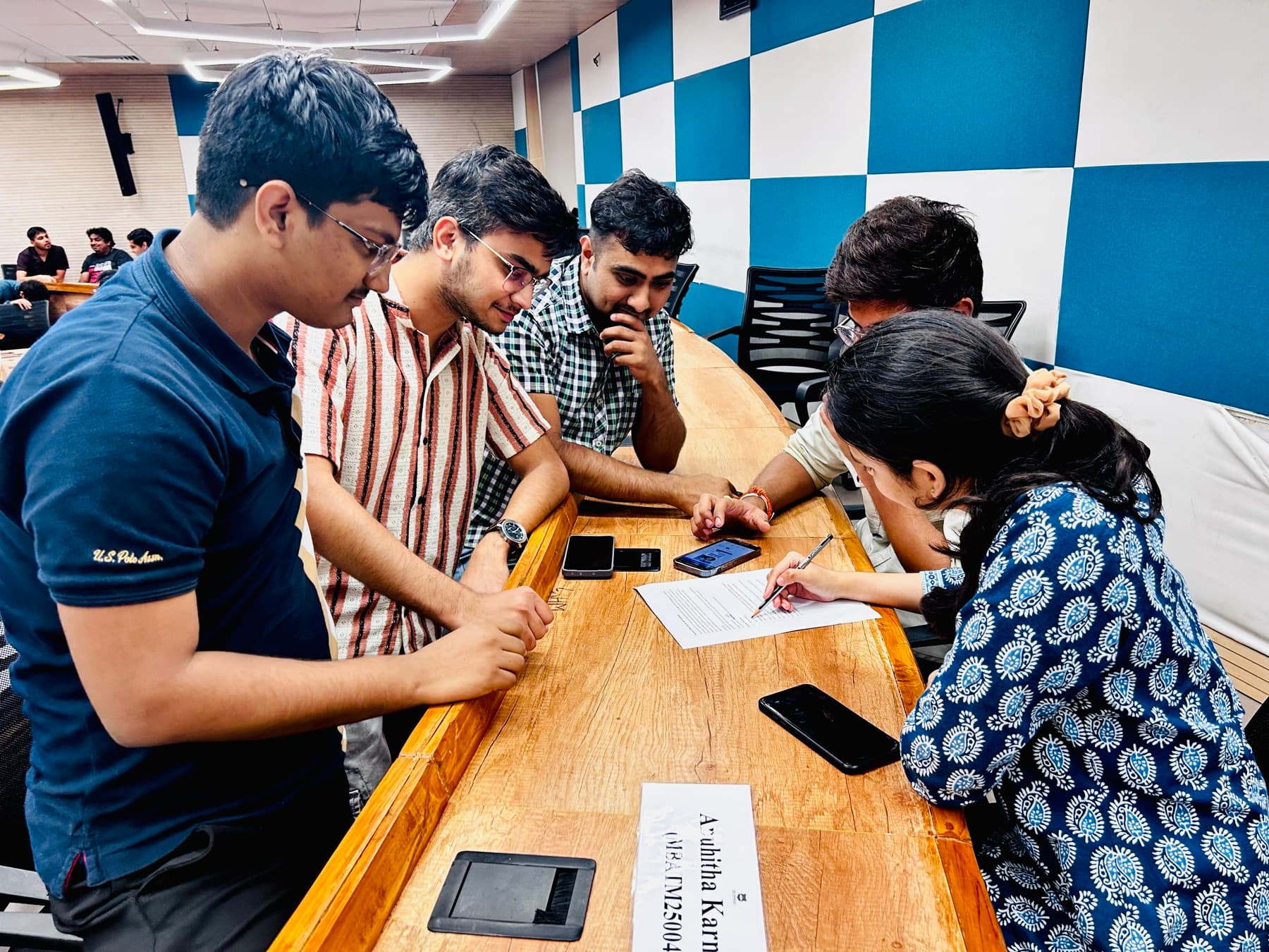 Students collaborating around a table at IIM Sirmaur